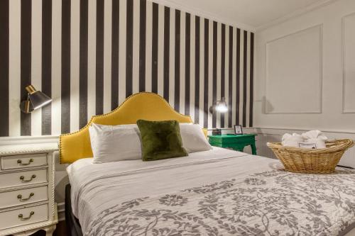 a bedroom with a large bed with a yellow headboard at New Hotel Collection Downtown St Pete in St Petersburg