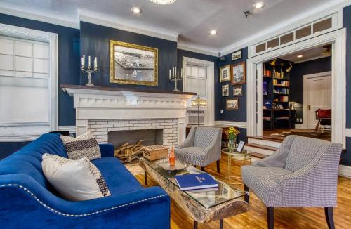 a living room with blue walls and a fireplace at New Hotel Collection Downtown St Pete in St Petersburg