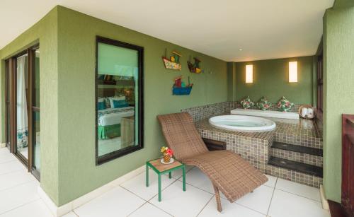 a bathroom with a tub and a sink at Vivá Porto de Galinhas Resort in Porto De Galinhas