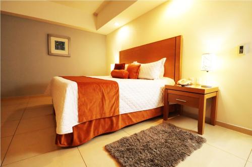 a bedroom with a large bed with a nightstand and a bed sidx sidx sidx at HB Córdoba in Córdoba