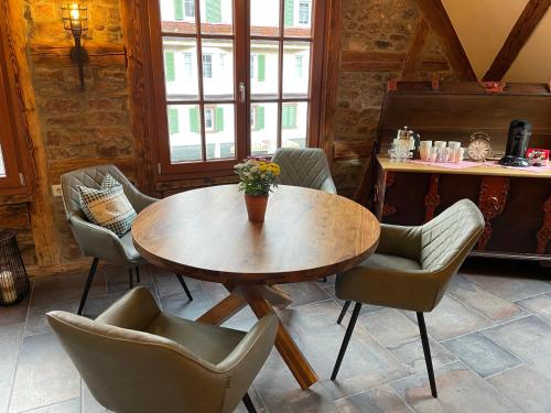 a dining room with a wooden table and chairs at Muggel Apartments in Alpirsbach