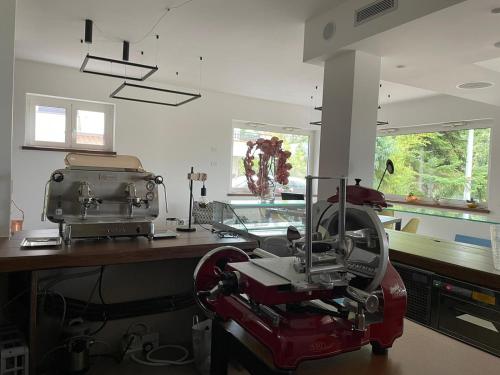 a kitchen with a red machine sitting on a counter at Alba Relais in Nemoli