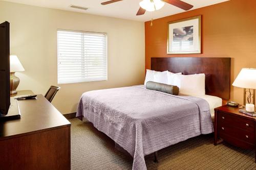 a hotel room with a bed and a television at Affordable Suites Mooresville in Mooresville