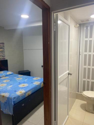 a bedroom with a bed and a shower and a toilet at Fuentes House in San Andrés