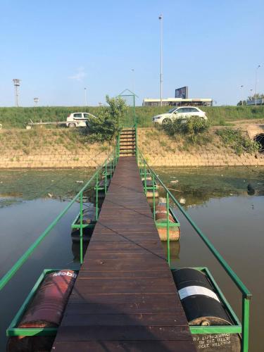 a wooden dock with several boats on the water at Nature and atractive house in Belgrade
