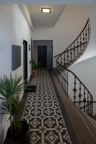 a hallway with a tile floor and a staircase at Penzion Apartmány Resident in Poděbrady