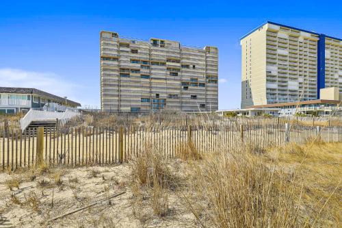 a tall building and a fence in front of a building at Fountainhead Towers in Ocean City