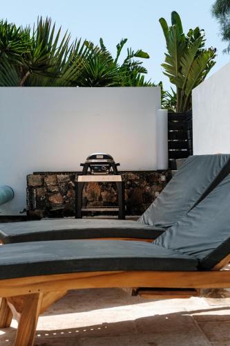 two beds sitting next to a wall with plants at Casa Maeva with heated pool in El Roque in Cotillo