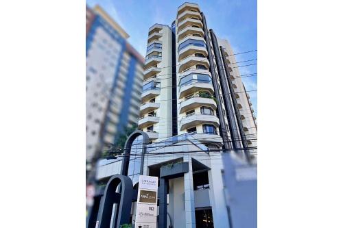 a tall building with a sign in front of it at Lindacap Flat Residence in Florianópolis