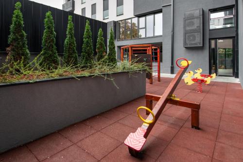 a childs toy on a table in front of a building at LUST PREMIUM Apartments in Kragujevac
