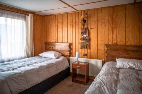 Giường trong phòng chung tại Hostal Lejana Patagonia