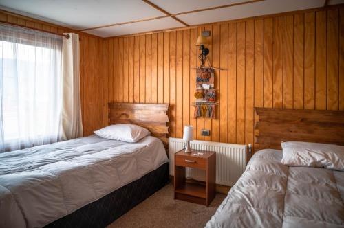 Postel nebo postele na pokoji v ubytování Hostal Lejana Patagonia