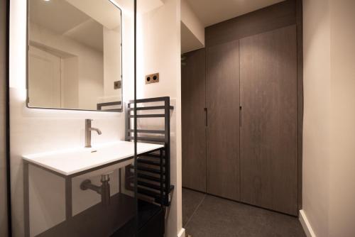 a bathroom with a sink and a mirror at MBM - Luxury home in marais in Paris