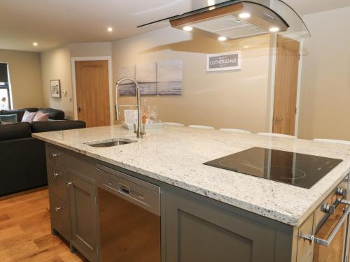 a kitchen with a sink and a counter top at 1 Stansfield Mews in Keighley