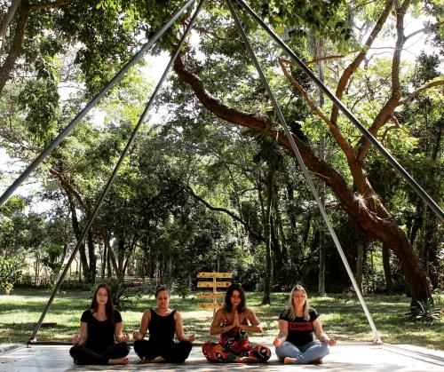a group of women sitting on the ground in a park at Gaia Hospedagem Holística in Brotas