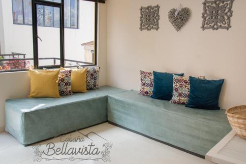 a room with pillows sitting on a bench at Cabaña Bellavista in Iza