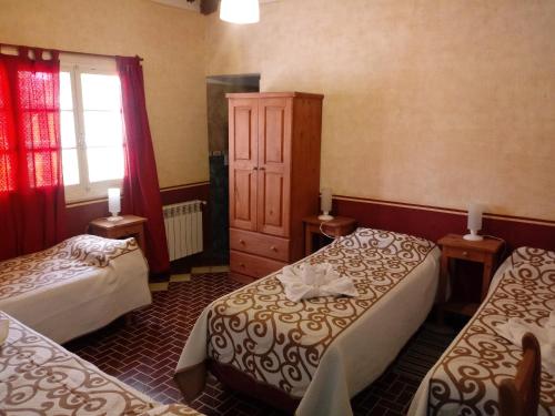 Ένα ή περισσότερα κρεβάτια σε δωμάτιο στο Hosteria Nuevo Sol