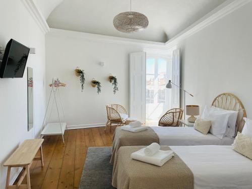 Ένα ή περισσότερα κρεβάτια σε δωμάτιο στο Casa Soure Suites and Apartments
