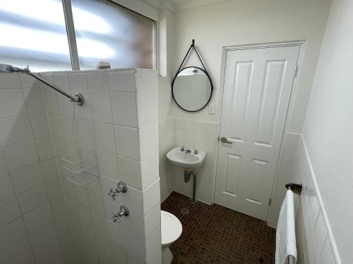 a bathroom with a toilet and a sink and a mirror at Royal Hotel Motel Scone in Scone