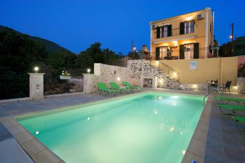 a swimming pool in front of a house at stunning tranquil villa with private pool in Sami