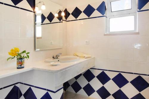 a bathroom with a sink and a mirror at Holiday Home Praia da Luz - ALG01376-F in Mato Porcas