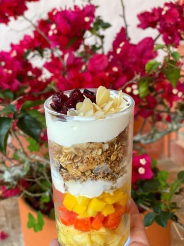 a glass jar of food with fruit and whipped cream at Granja del Cafe Hotel y Centro de convenciones in Venecia