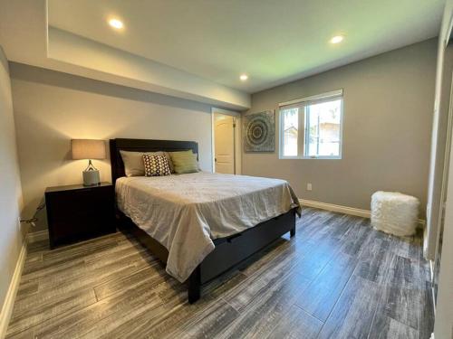 a bedroom with a large bed and a window at Newly Built Townhouse - Prime Hollywood Location in Los Angeles
