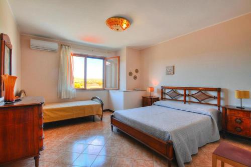 a bedroom with two beds and a window at Holiday Home Floridia - ISI02100a-FYB in Floridia