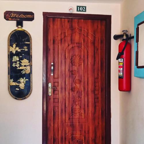 a wooden door in a room with a fire hydrant at Paradise corner in Pondicherry