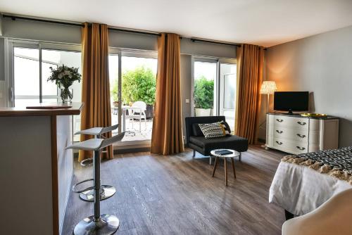 a hotel room with a bed and a chair at Hôtel La Réserve in Saint-Jean-de-Luz