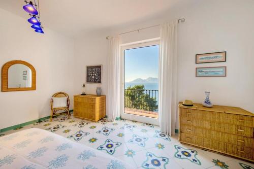 a bedroom with a bed and a large window at Villa Conchiglia, Massa Lubrense in Massa Lubrense