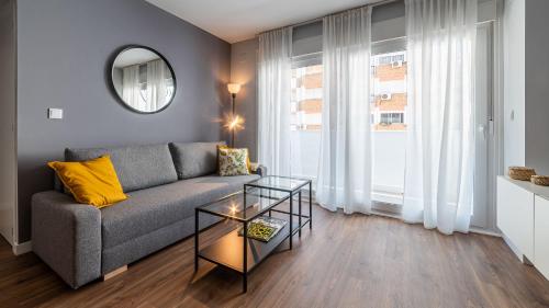 a living room with a couch and a table at Apartamento Luis de Vargas in Huelva