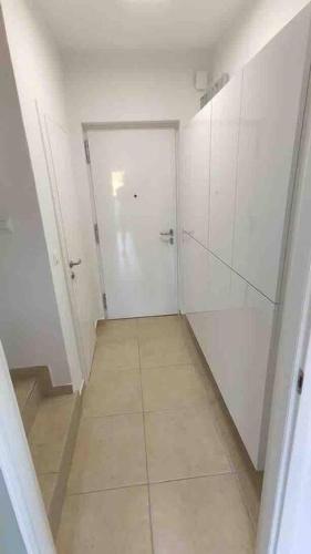 a white hallway with a door and a tiled floor at Villa Mala - Pool - Jacuzzi - 5 min. zum Meer in Trogir