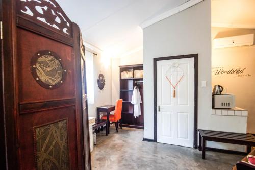 a hallway with a door leading to a room at Winterton Country Lodge @ Rose Cottage in Winterton