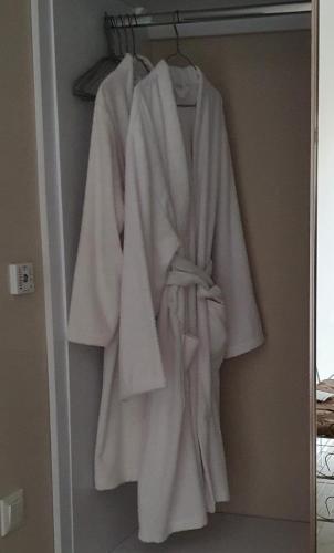 a robe hanging on a rack in a closet at апартаменти квартира in Chortkiv