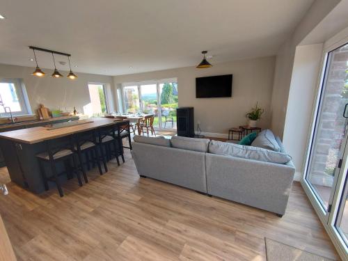 a living room with a couch and a table at Old Brewery Barn, Ullswater, Lake District in Penrith