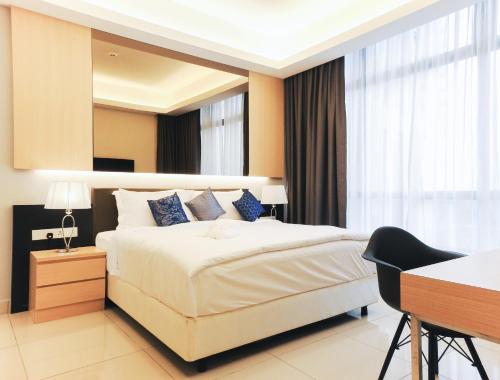 a bedroom with a large bed and a large window at Grand Ion Delemen Hotel in Genting Highlands