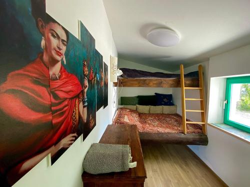 a bedroom with a painting of a woman on the wall at Mexican style chalett at lake Balaton in Kisapáti
