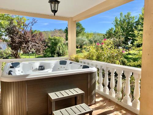 a jacuzzi tub on the porch of a house at Casa Rural - Suerte (+Piscina) in Illana