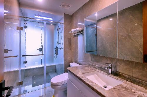 a bathroom with a toilet and a sink and a shower at Mayu Valley Hot Spring Homestay in Tengchong