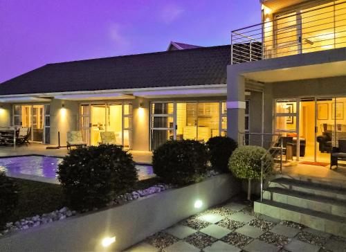 a house with a swimming pool at night at Harbour Cottages, Humewood in Port Elizabeth