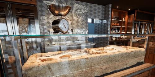 a glass display case in a museum with a large stone bench at Ostseehotel Midgard in Damp in Damp