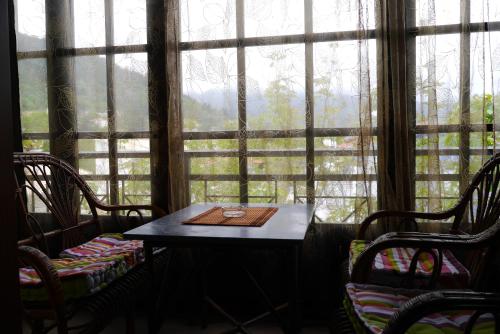 a table and chairs in front of a large window at Blue Sea Beach Hotel in Skala Potamias