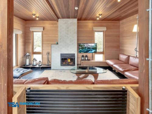 a living room with a couch and a fireplace at Milkwood 3 Chalet in Thredbo