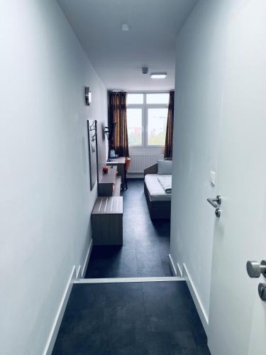a hallway with a living room with a couch at Hotel Terminal One in Sindelfingen