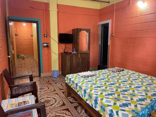 a red room with a bed and a mirror at Nimmu Guest House & Restaurant Gokarna in Gokarna