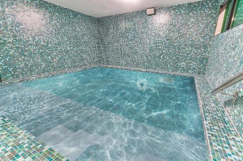 a large swimming pool in a room with tiles at Elite Apartments in Kolašin