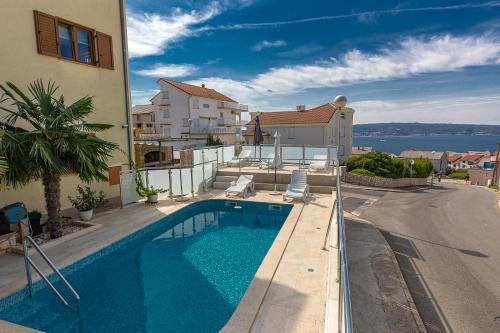 a swimming pool on the side of a building at Apartments Villa Ivka in Crikvenica