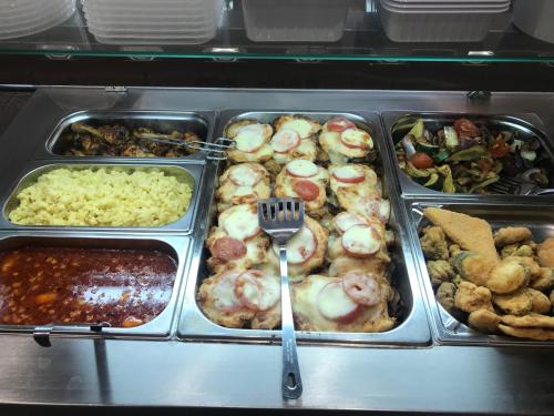 a tray of food with a fork in it at Termál Apartmanház in Veresegyház