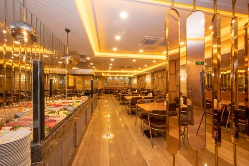 a restaurant with tables and chairs in a room at Ramada By Wyndham Istanbul Pera Taksim in Istanbul